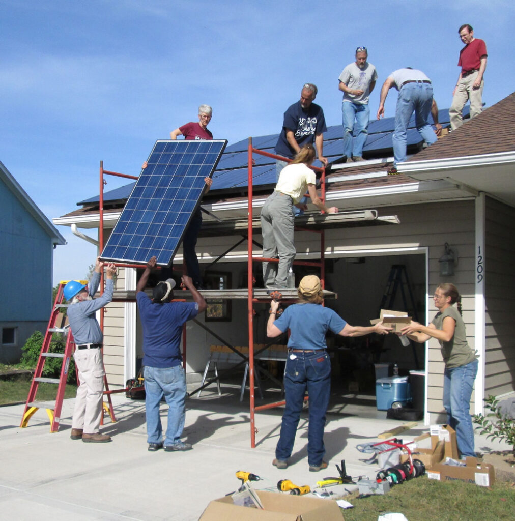 FHREEC Sunraisers install solar panels on a homeowner's roof
